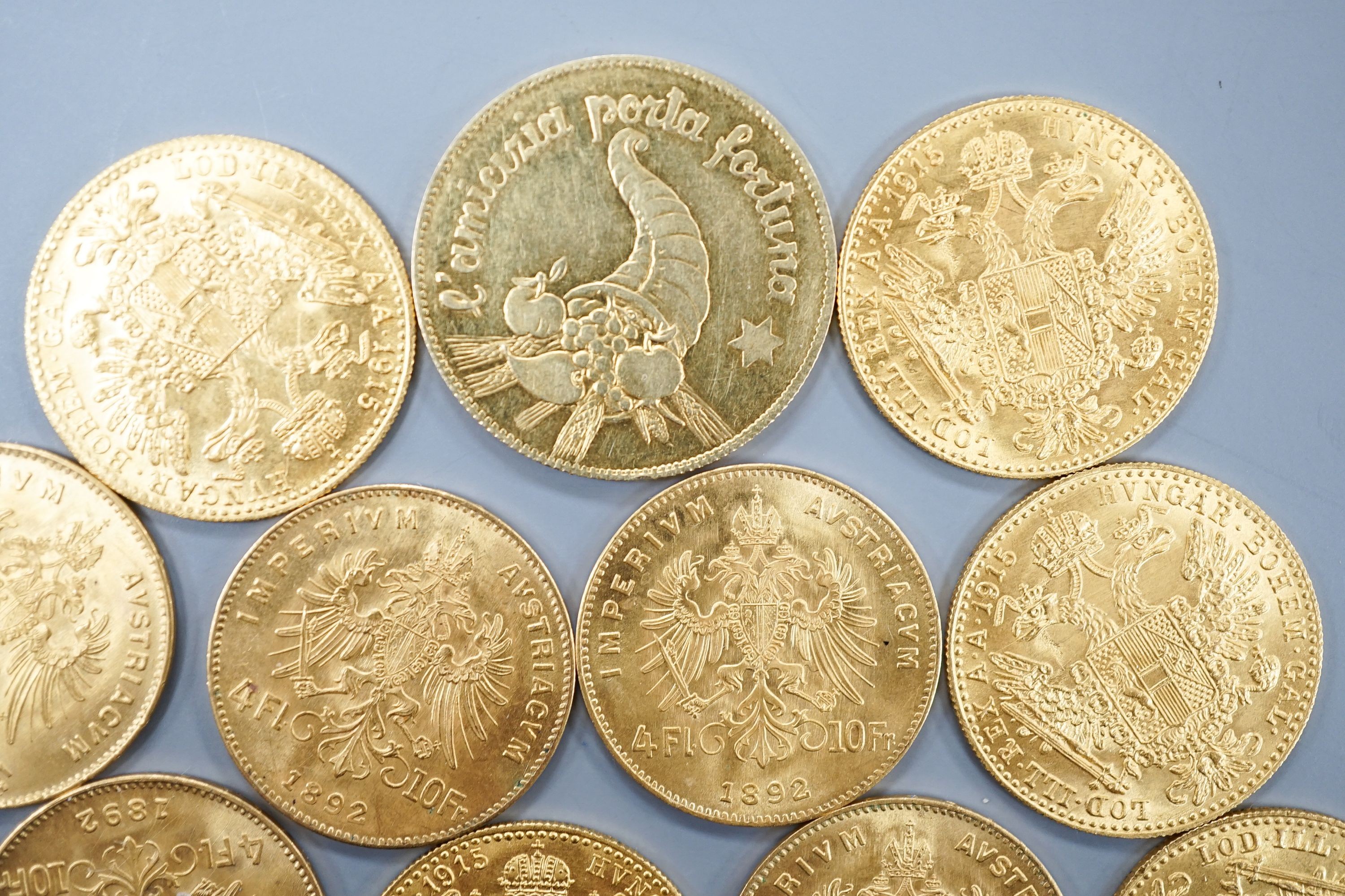 Ten Austrian gold Ducats (re-strikes) and an Italian 750 yellow metal 'I Star Lina de Amicizia'